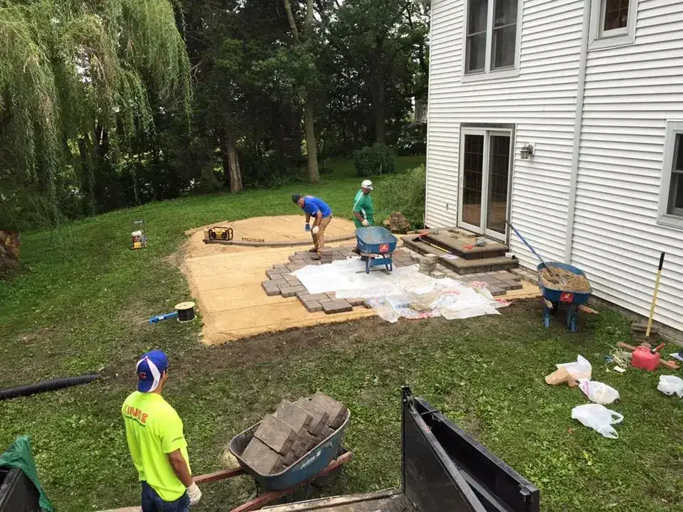 Crew laying pavers on the compacted base