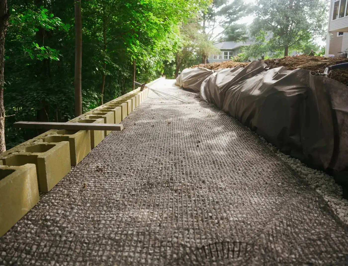Gravel drainage base and first course of block laid along a slope