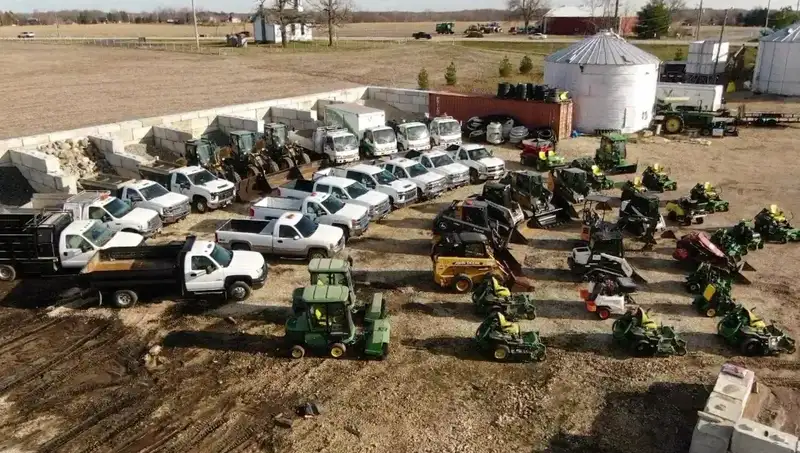 Valley Outdoor mowers, trailers and trucks lined up in a lot