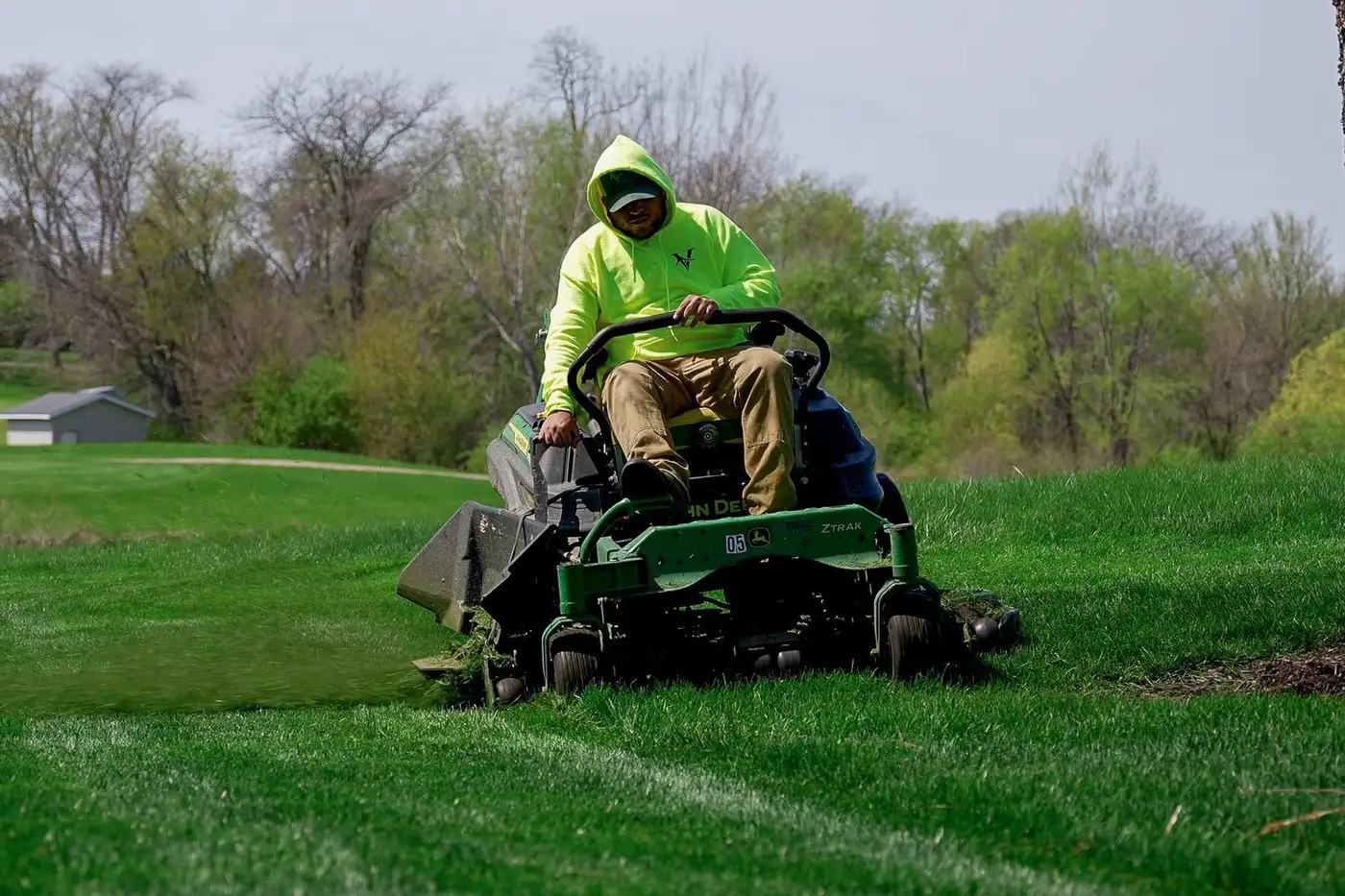 Valley Outdoor crew member mowing on a zero-turn mower